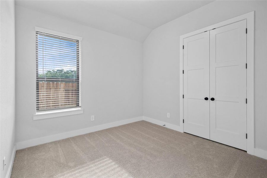 Step into this bright and airy secondary bedroom! It offers a tranquil space to unwind. The large window illuminates the room's sloped ceiling and neutral tones, creating a cheerful and airy environment. This room also features a spacious closet. Step into this bright and airy secondary bedroom! It offers a tranquil space to unwind. The large window illuminates the room's sloped ceiling and neutral tones, creating a cheerful and airy environment. This room also features a spacious closet.