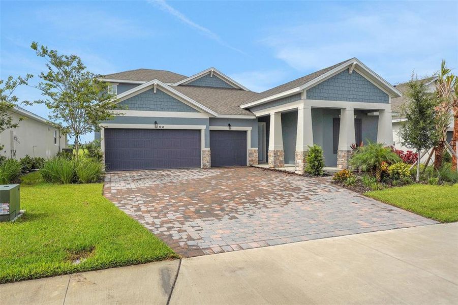 Front exterior of a new home in Seaire, Parrish, FL, highlighting curb appeal (Image 19). Front exterior of a new home in Seaire, Parrish, FL, highlighting curb appeal (Image 19).