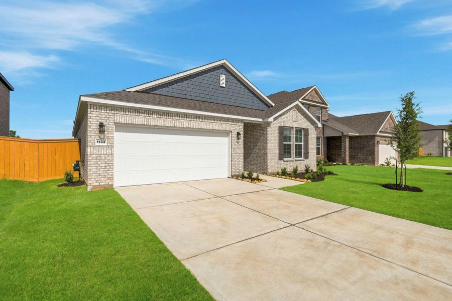 Front exterior of a new home in Sunterra Lakes, Brookshire, TX, highlighting curb appeal (Image 2). Front exterior of a new home in Sunterra Lakes, Brookshire, TX, highlighting curb appeal (Image 2).