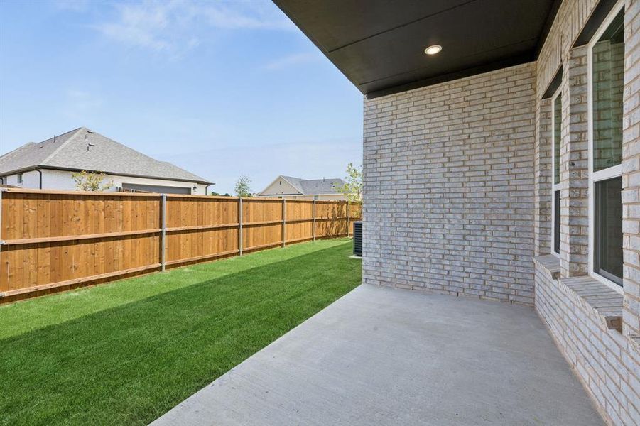 Dining al fresco is in your future on this lovely covered patio.