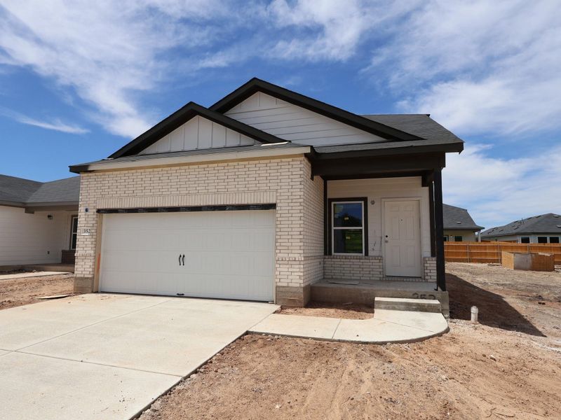 Front exterior of a new home in Cool Water, Jarrell, TX, highlighting curb appeal (Image 2). Front exterior of a new home in Cool Water, Jarrell, TX, highlighting curb appeal (Image 2).