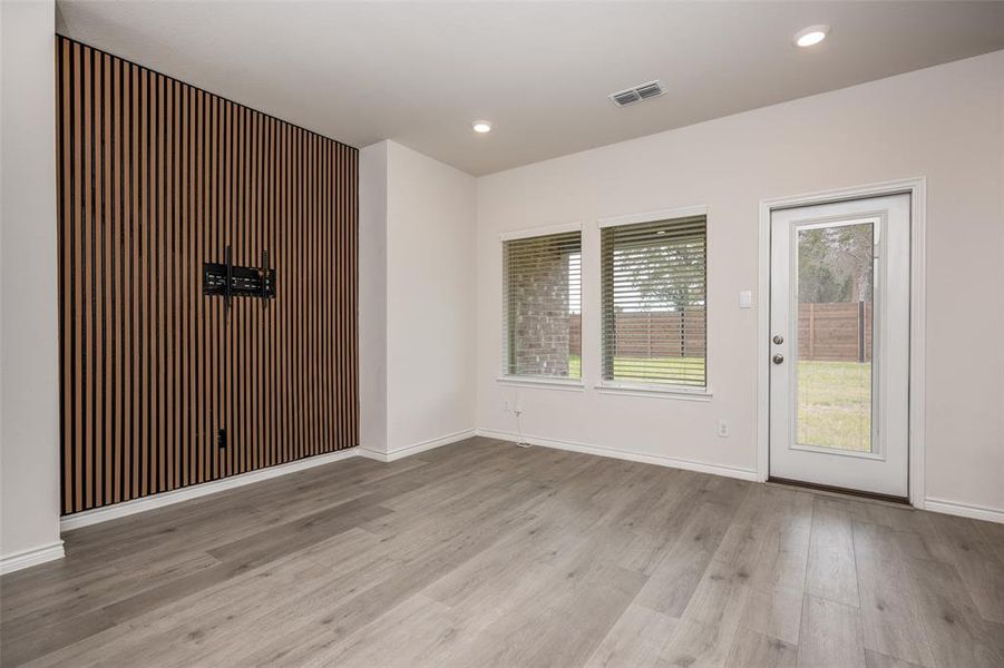 Empty room featuring light wood finished floors and recessed lighting