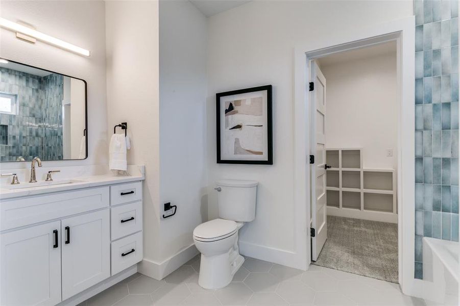 Bathroom with tile floors, vanity, and toilet