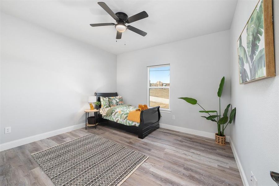 Bedroom featuring ceiling fan and light hardwood / wood-style flooring