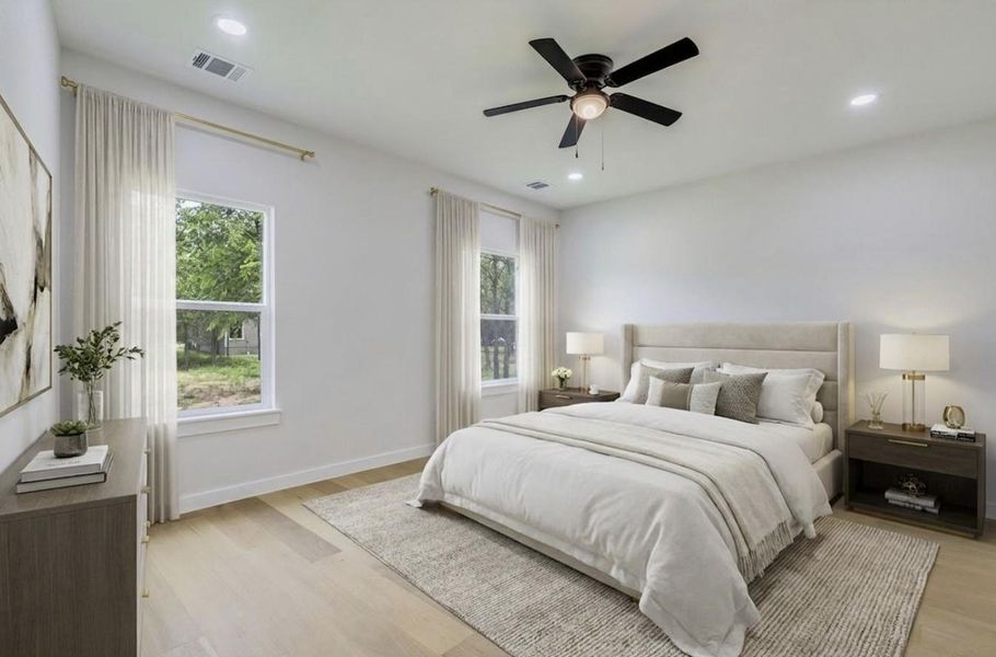 Virtually staged photo of bright primary bedroom with two picturesque windows and modern ceiling fan.