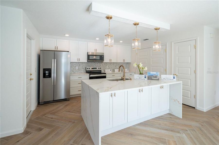 Love the kitchen with the waterfall island with quartz counter tops.