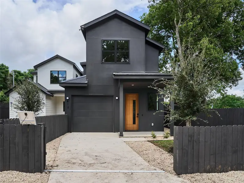 Modern home with concrete driveway and a garage Modern home with concrete driveway and a garage