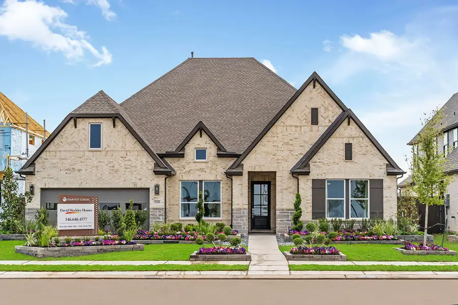 Front exterior of a new home in Harvest Green - Parkview Collection, Richmond, TX, highlighting curb appeal (Image 2). Front exterior of a new home in Harvest Green - Parkview Collection, Richmond, TX, highlighting curb appeal (Image 2).
