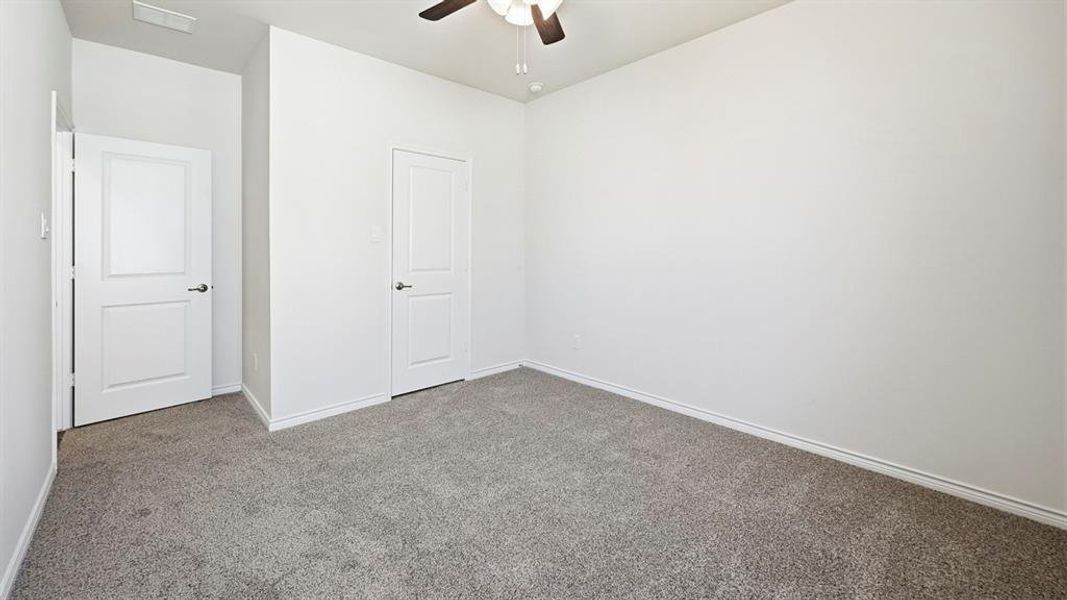 Unfurnished bedroom featuring carpet and ceiling fan