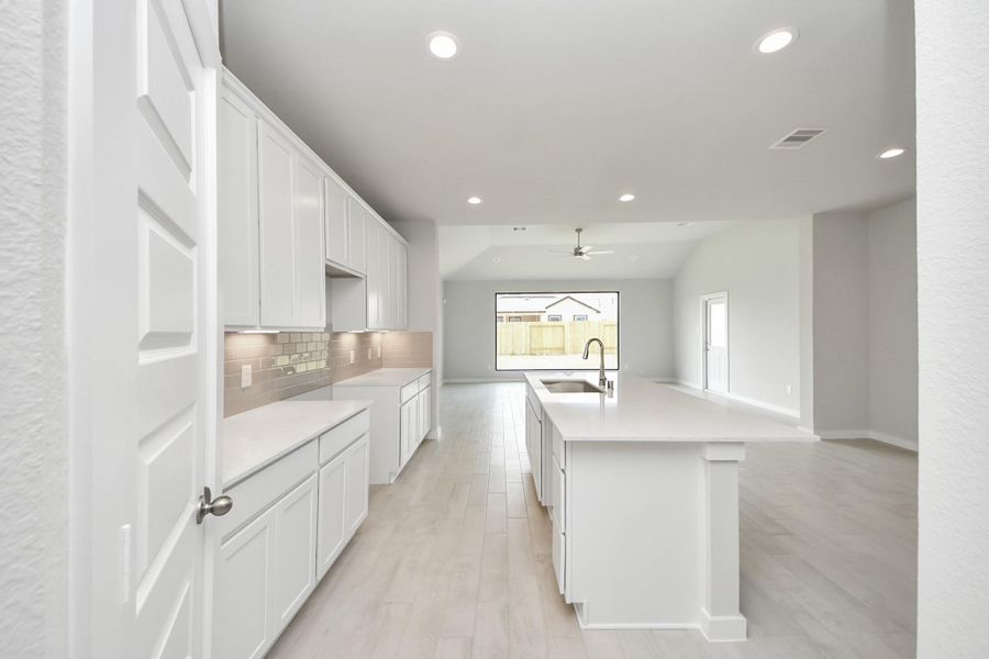 The kitchen is a culinary haven, featuring granite countertops, a tile backsplash, stainless steel appliances, 42” upper cabinets, and undercabinet lighting. The kitchen is a culinary haven, featuring granite countertops, a tile backsplash, stainless steel appliances, 42” upper cabinets, and undercabinet lighting.