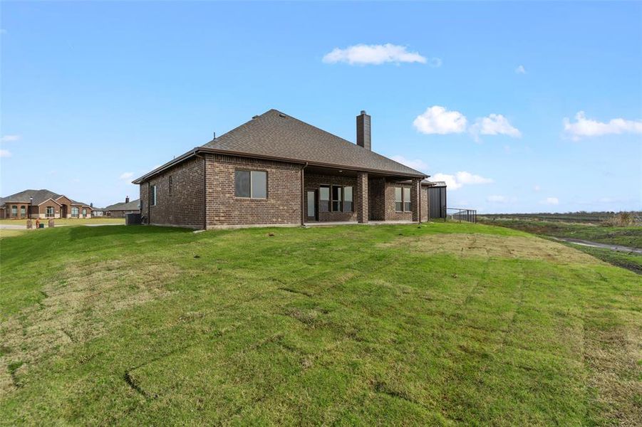 Rear view of property featuring a lawn