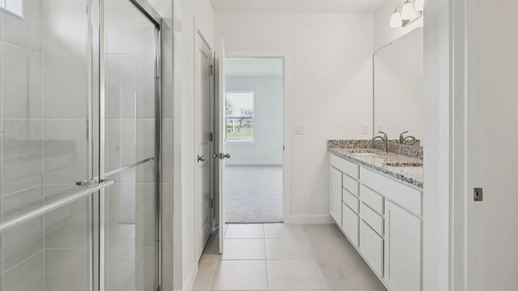 Primary En Suite Bath of the Baker Floor Plan by DRB Homes in Liberty Trace New Homes in Haines City