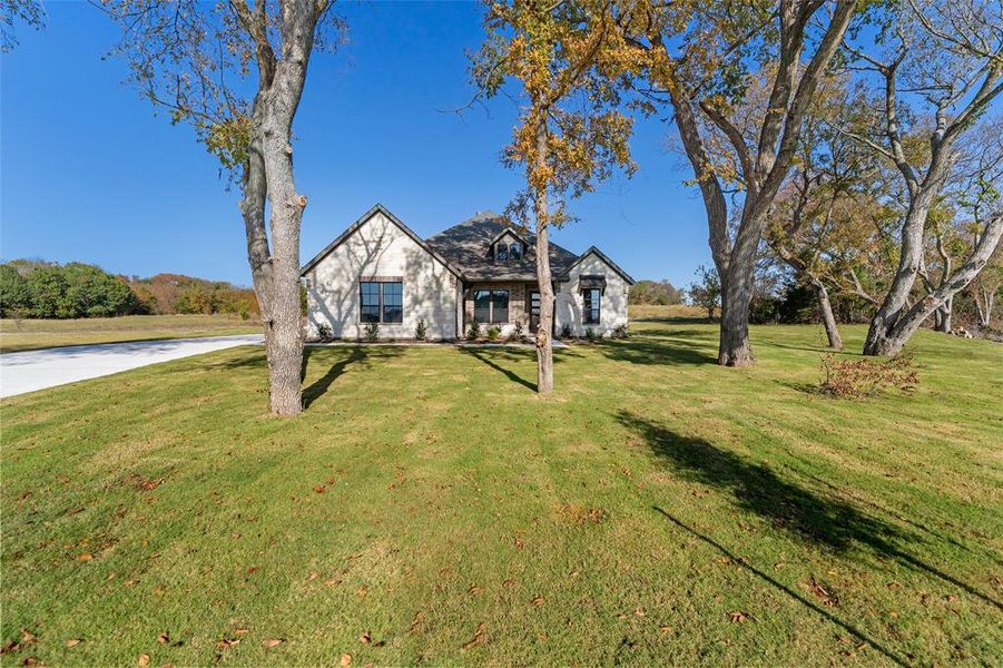 Front exterior of a new home in King Crossing Estates, Van Alstyne, TX, highlighting curb appeal (Image 24). Front exterior of a new home in King Crossing Estates, Van Alstyne, TX, highlighting curb appeal (Image 24).