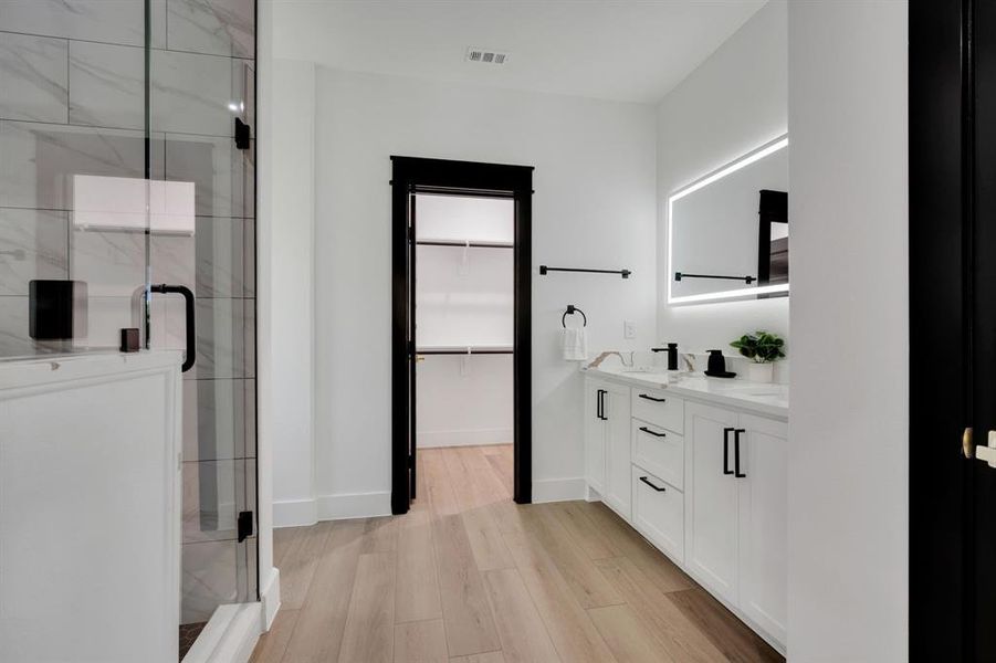 Custom vanity with double sinks and no-fog mirror.