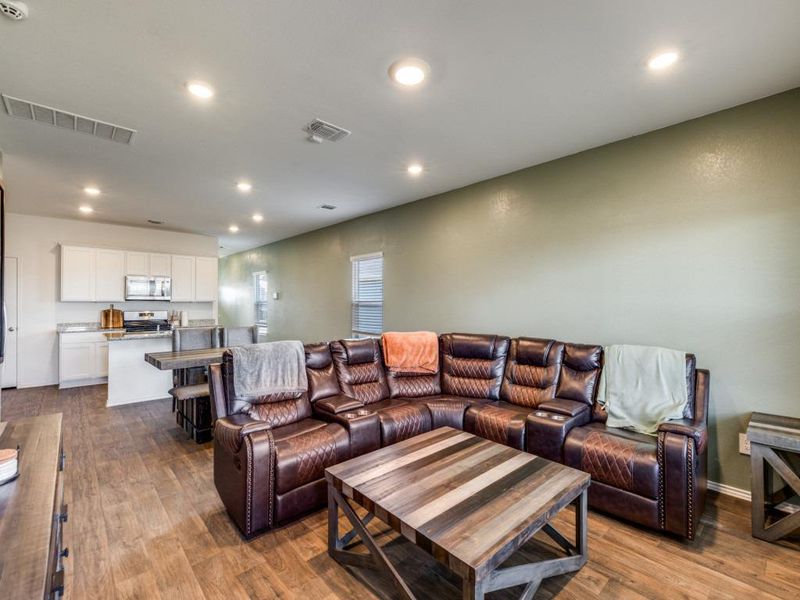 Living area with recessed lighting and dark wood finished floors