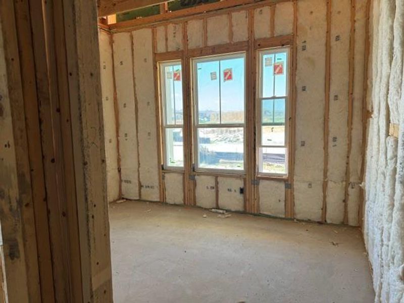 Framed walls and windows invite ample light into this future living space.