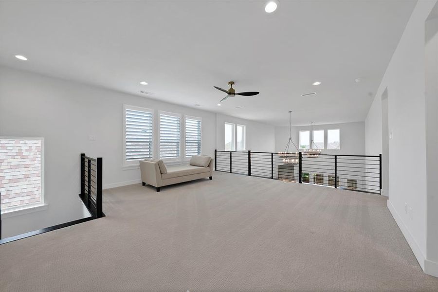 Spacious upper-level loft featuring recessed lighting, a ceiling fan, and light-colored carpeting Spacious upper-level loft featuring recessed lighting, a ceiling fan, and light-colored carpeting