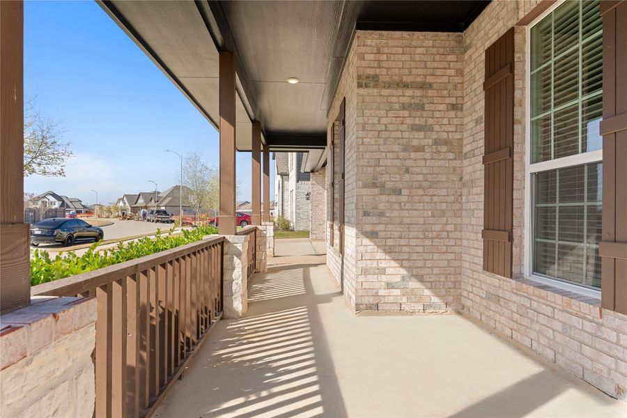 This extended covered porch offers a charming and welcoming approach to the home, ideal for morning coffee or evening conversations, with durable materials and classic finishes that reflect the care and attention poured into every detail of this Energy Star certified residence.
