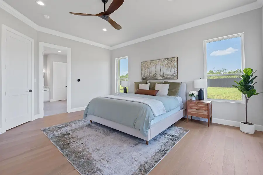 Bedroom with light wood finished floors, ornamental molding, recessed lighting, and a ceiling fan