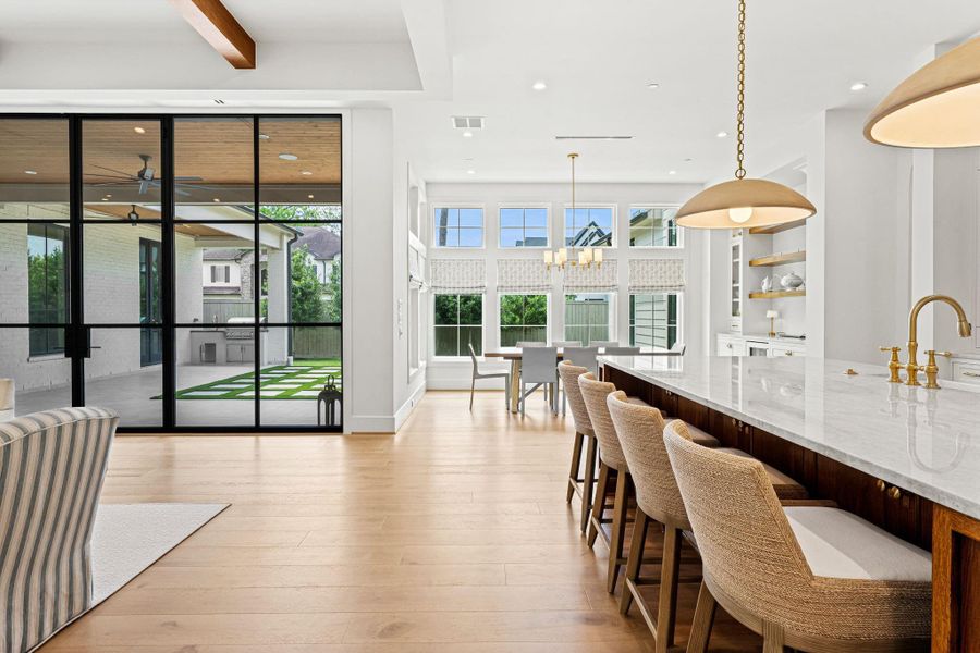 Walls of Sierra Pacific windows & French doors flood the space w/ natural light while seamlessly connecting to the covered patio. The open-concept layout flows effortlessly between the family room & kitchen, with the breakfast area just beyond—creating a bright, cohesive setting ideal for both everyday living & entertaining. Walls of Sierra Pacific windows & French doors flood the space w/ natural light while seamlessly connecting to the covered patio. The open-concept layout flows effortlessly between the family room & kitchen, with the breakfast area just beyond—creating a bright, cohesive setting ideal for both everyday living & entertaining.