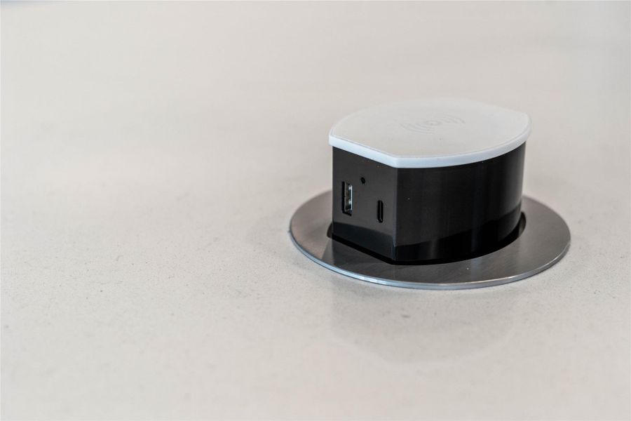 This sleek, pop-up electrical receptacle is a standout functional feature of the modern kitchen island, designed to keep the workspace clean and uncluttered.