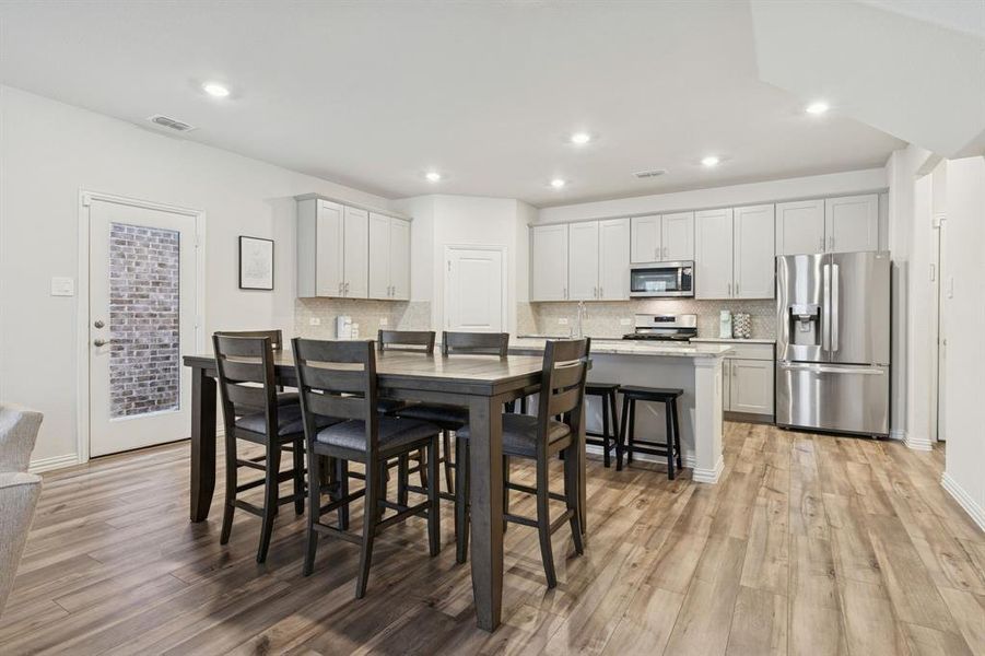 Dining room featuring light wood finished floors and recessed lighting