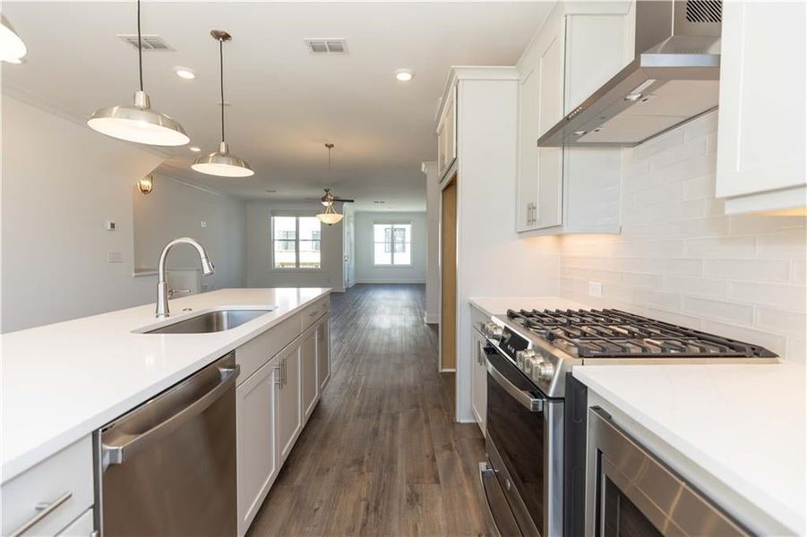 Kitchen opens to the dining area*Photo of model home in a different community. Used for illustrative purposes only*