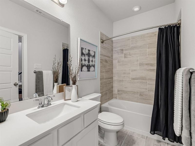 The pristine Hollywood bathroom is smartly positioned between the second bedroom and office for dual accessibility.