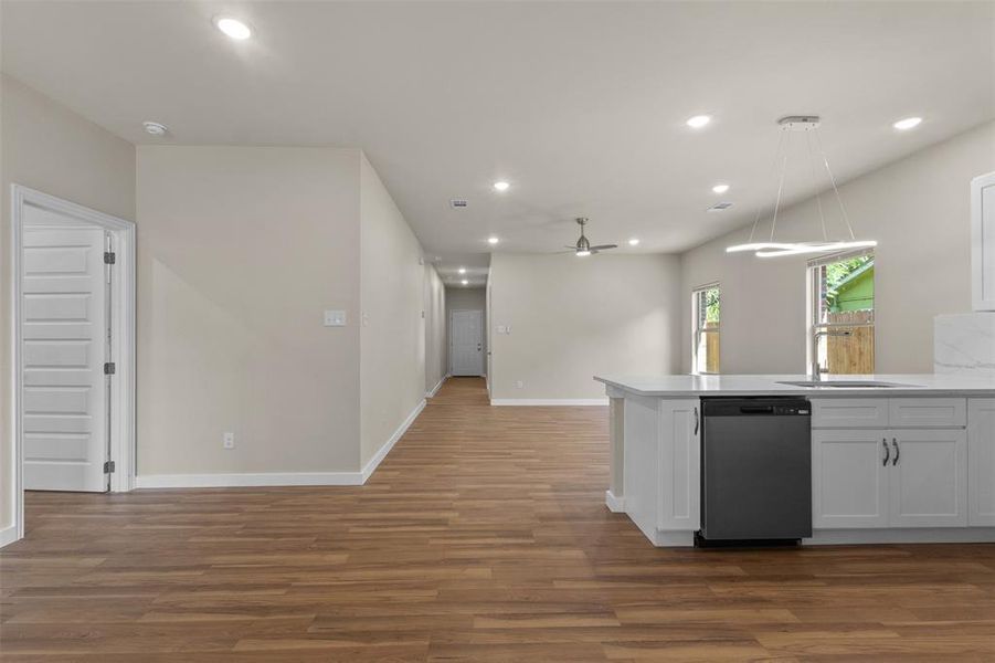 Kitchen featuring open floor plan, white cabinetry, recessed lighting, dark wood-style floors, and a peninsula Kitchen featuring open floor plan, white cabinetry, recessed lighting, dark wood-style floors, and a peninsula