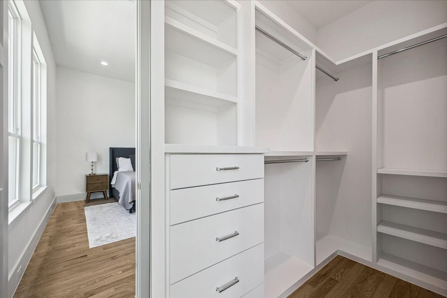 Oversized walk-in closet with custom built-ins and exceptional storage.