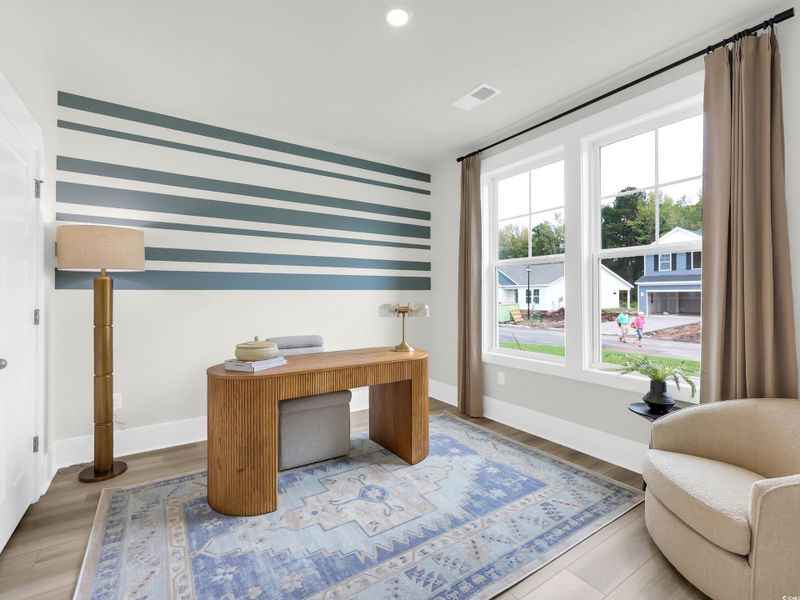 Office space featuring radiator heating unit, recessed lighting, and wood finished floors Office space featuring radiator heating unit, recessed lighting, and wood finished floors