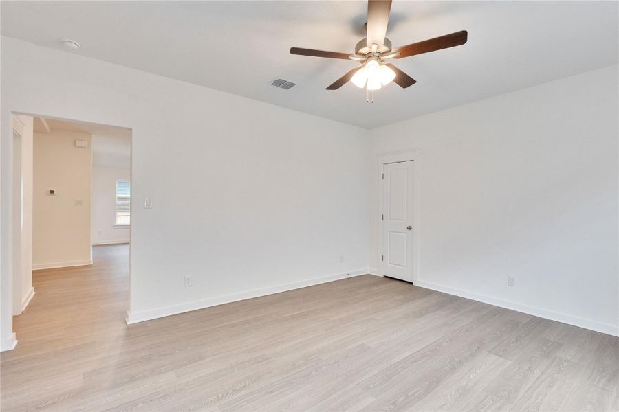 Unfurnished room featuring light wood-style floors and ceiling fan Unfurnished room featuring light wood-style floors and ceiling fan