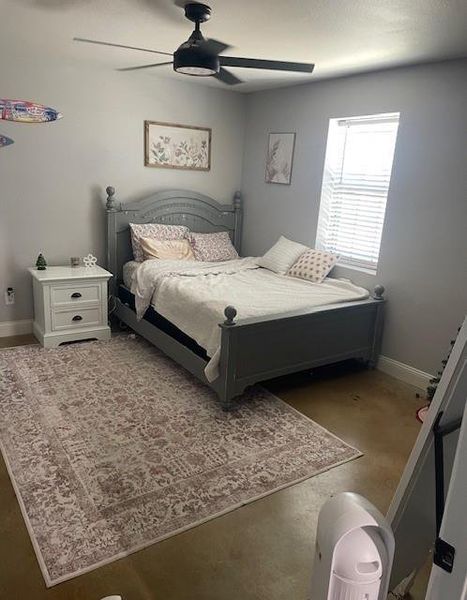 Carpeted bedroom with ceiling fan