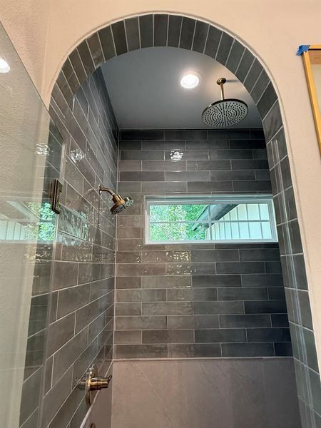 Bathroom featuring tiled shower