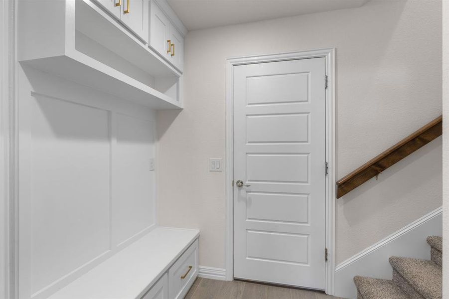 Mudroom featuring light wood-style floors and baseboards Mudroom featuring light wood-style floors and baseboards