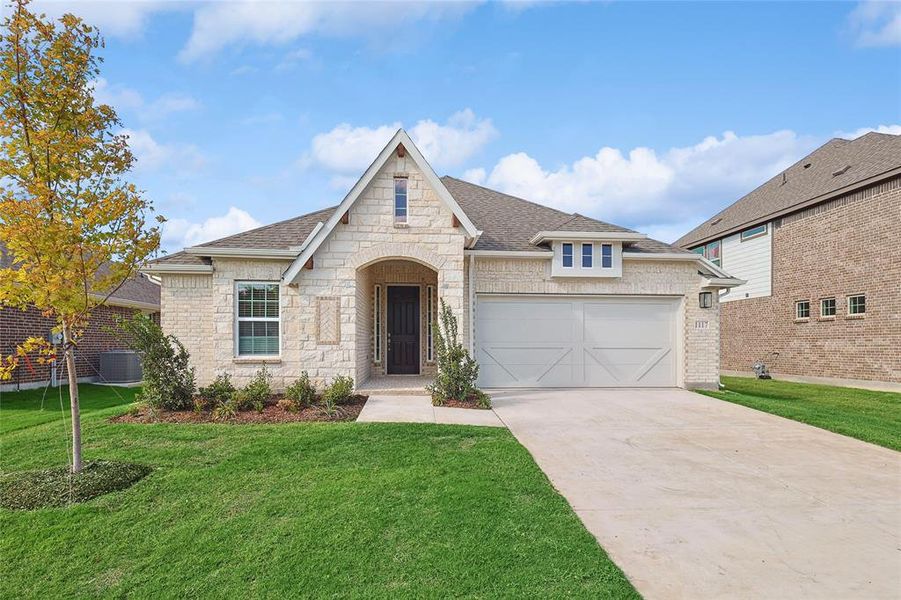 View of front of property with a front yard and central AC