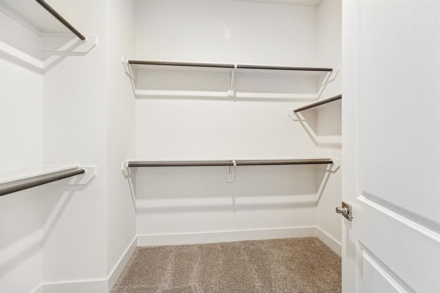 Shown here is one o f the two primary closets that is spacious andfeatures double rods for plenty ofclothes.