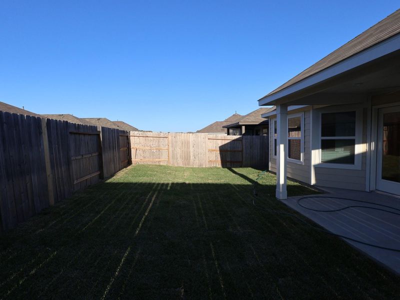 Exterior details and patio area of a home in Pinewood at Grand Texas, New Caney (Image 20).