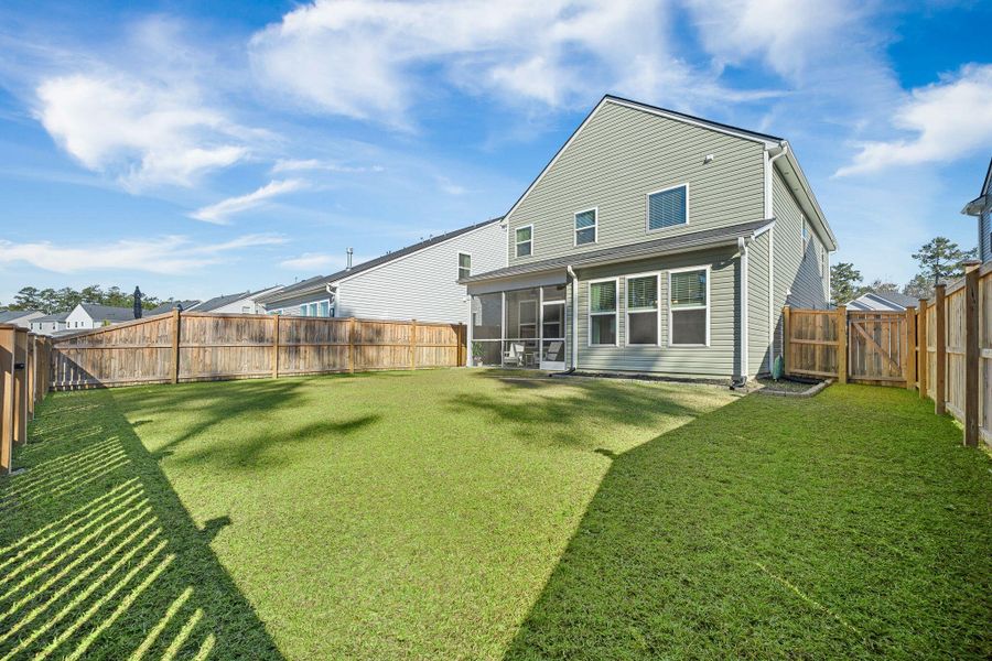 Exterior details and patio area of a home in Jasmine Point at Lakes of Cane Bay, Summerville (Image 30).
