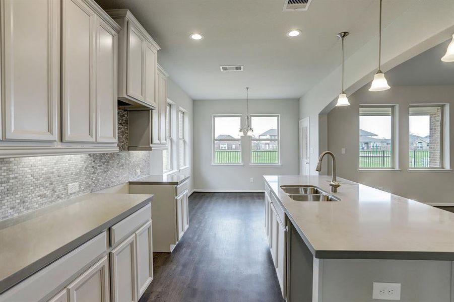 Kitchen with island (*Photo not of actual home and used for illustration purposes only.)