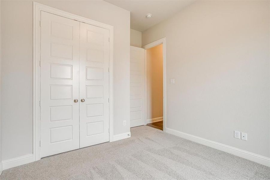 Unfurnished bedroom with carpet floors and a closet