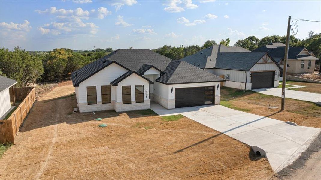 Front exterior of a new home in , Granbury, TX, highlighting curb appeal (Image 20). Front exterior of a new home in , Granbury, TX, highlighting curb appeal (Image 20).