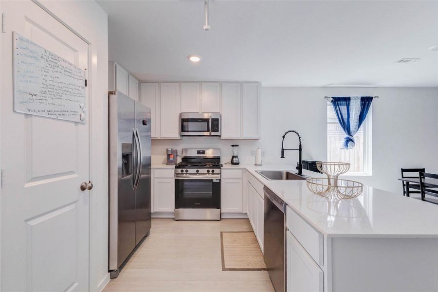 Well-appointed kitchen with generous counter space, pantry, and views into the main living area.