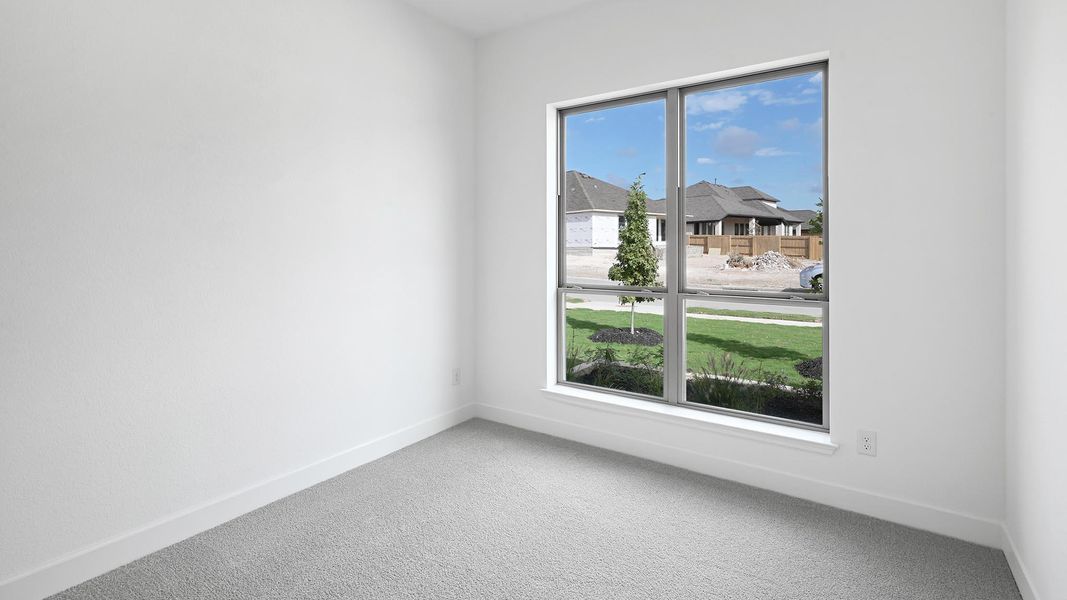 Unfurnished room featuring carpet flooring and a residential view