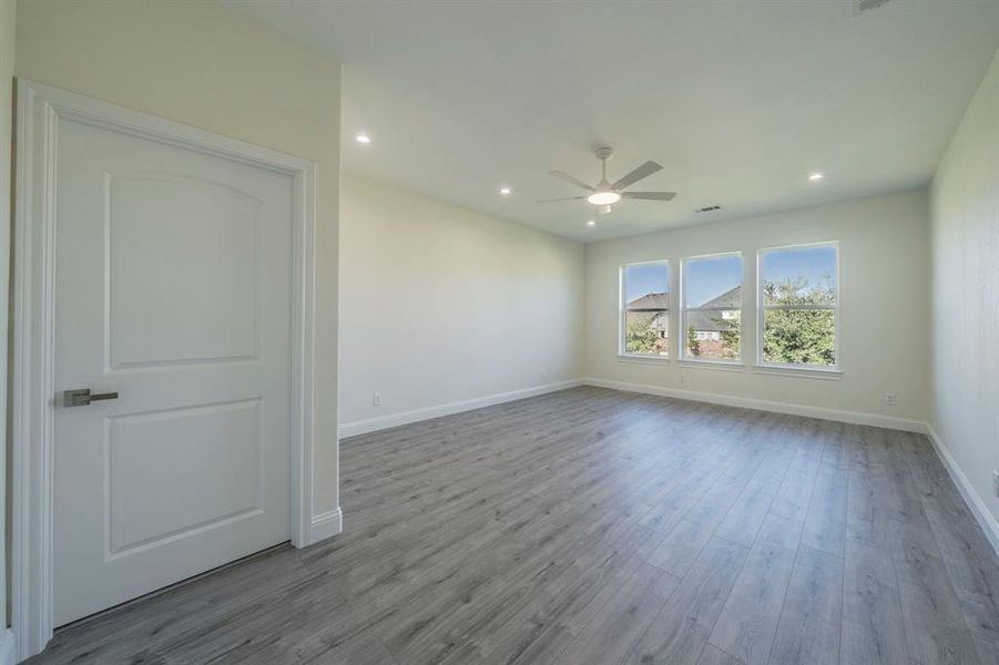 Spare room with light wood-style floors, recessed lighting, and ceiling fan Spare room with light wood-style floors, recessed lighting, and ceiling fan