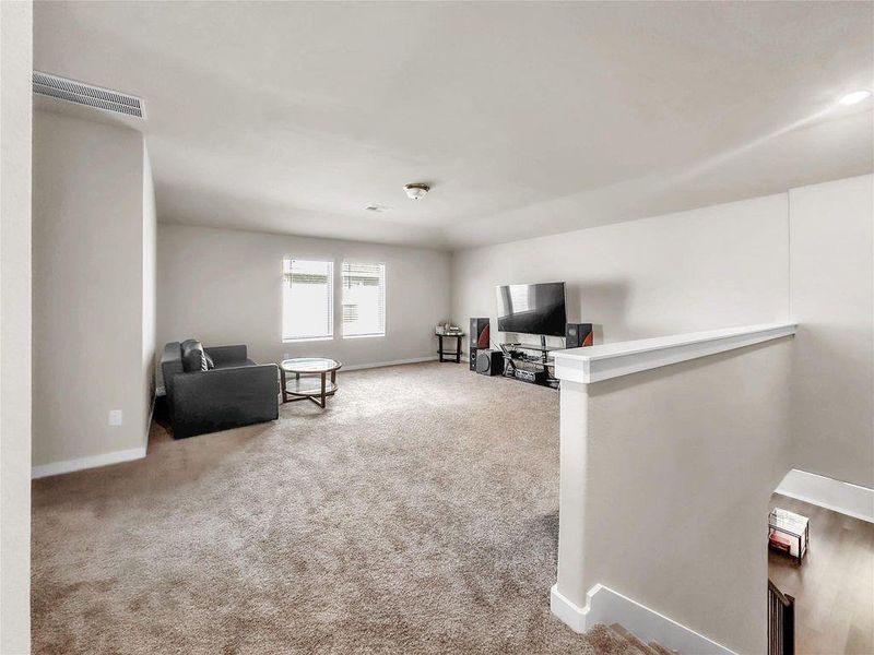 Spacious and light-filled living room featuring an open-concept layout, high ceilings, and seamless flow into the kitchen and dining areas—perfect for everyday living and entertaining.