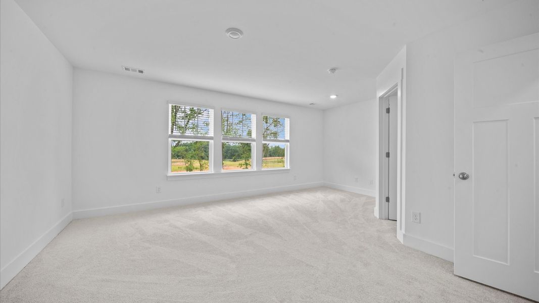 Plush carpeted, spacious primary suite in two story townhome at Ransdell Pointe by DRB Homes in Spartanburg, SC