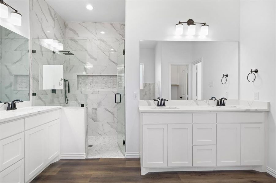 Bathroom featuring vanity, wood-type flooring, and an enclosed shower