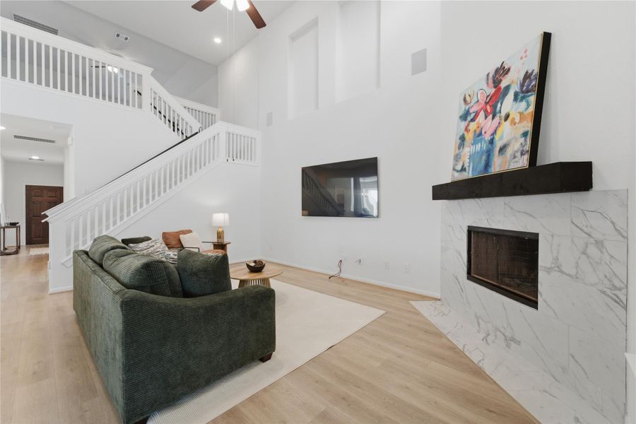 A spacious living area with soaring ceilings and a contemporary fireplace provides a welcoming ambiance. A spacious living area with soaring ceilings and a contemporary fireplace provides a welcoming ambiance.