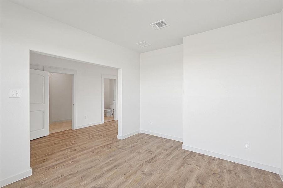 Empty room featuring light wood-type flooring